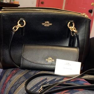 The is a coach handbag it comes with the wallet and the shoulder strap